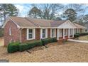 Attractive brick home boasting a classic design, manicured landscaping, and inviting front porch at 210 Heritage Cir, Mcdonough, GA 30253