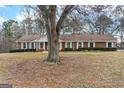 Lovely brick home showcasing large front yard, white trim, and well-maintained landscaping at 210 Heritage Cir, Mcdonough, GA 30253