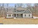 Charming home with a combination of gray siding and stone accents creating a balanced look at 6025 Old Timber Trl # 11, Douglasville, GA 30135