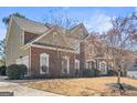 Beautiful home featuring manicured lawn, multi-pane windows, and brick/stone combination at 6142 Golf View Xing, Locust Grove, GA 30248
