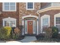 Charming front entryway featuring a wreath, sidelights and brick/stone facade at 6142 Golf View Xing, Locust Grove, GA 30248