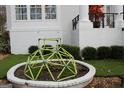 Fun backyard play area with climbing structure surrounded by manicured landscaping and lush greenery at 337 Lakeshore Dr, Berkeley Lake, GA 30096