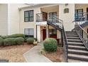 Charming condo building featuring tidy landscaping and eye-catching red doors at 555 Windchase Ln, Stone Mountain, GA 30083