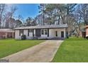 Beautifully maintained single story home with a long driveway and a lush, green lawn at 3047 Horse Shoe Se Dr, Atlanta, GA 30316