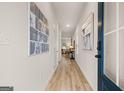 Inviting foyer with wood floors, modern artwork and transom window at the door at 44 Leggit Dr # 179, Villa Rica, GA 30180