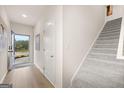 Bright entryway with open staircase and wood-look flooring at 44 Leggit Dr # 179, Villa Rica, GA 30180