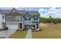 Beautiful townhome with an attached garage and professionally landscaped front yard at 44 Leggit Dr # 179, Villa Rica, GA 30180