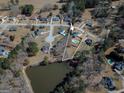 Aerial view showcasing a property with a pool in a serene, wooded neighborhood setting at 140 Surrey Park Dr, Fayetteville, GA 30215