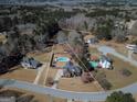 Aerial view of a home with a pool, surrounded by lush greenery and neighborhood at 140 Surrey Park Dr, Fayetteville, GA 30215