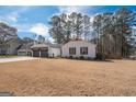 Charming single-story home with two-car garage on spacious lot, beautiful tree line in the background at 100 Lanyard Bnd, Peachtree City, GA 30269