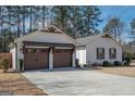 Charming single-story home with two-car garage on spacious lot, beautiful tree line in the background at 100 Lanyard Bnd, Peachtree City, GA 30269