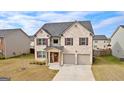 Lovely two-story home with brick details, attached garage, and a welcoming front entrance at 1756 Beckworth Ln, Hampton, GA 30228