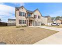 Attractive two-story house featuring a brick front, an attached two-car garage, and well-maintained landscaping at 1756 Beckworth Ln, Hampton, GA 30228