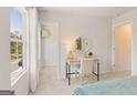 Bedroom with a cozy desk, adjacent walk-in closet, and a window with a view of the outdoors at 988 Sutherland Lane # 33, Lawrenceville, GA 30043