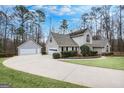 View of the house showing the driveway leading to a detached two-car garage at 238 Harvest Trce, Sharpsburg, GA 30277