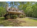 Inviting home with a covered porch, offering a perfect spot for relaxation and enjoying the outdoors at 9209 W Banks Mill Rd, Winston, GA 30187