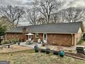 Backyard featuring a patio with dining set, surrounded by landscaping and mature trees at 365 Jordan Dr, Tucker, GA 30084