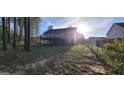 Backyard view featuring a large wooden deck with a fenced in yard and mature trees at 220 Joe Dr, Temple, GA 30179