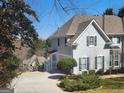 Charming home exterior features a two-car garage and a covered front porch entrance at 718 Avalon Way, Peachtree City, GA 30269