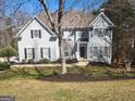 Stunning traditional-style home boasts pristine landscaping, dark shutters, and stone accents at 718 Avalon Way, Peachtree City, GA 30269
