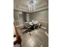 Dining area featuring hardwood floors and stylish chandelier at 3685 Washington Rd, East Point, GA 30344
