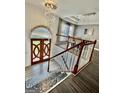 Elegant foyer with a wooden staircase and stunning crystal chandelier at 3685 Washington Rd, East Point, GA 30344