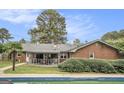 Backyard view featuring an in-ground pool and a covered porch at 1083 Hampton Rd, Hampton, GA 30228