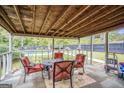 Relaxing screened-in porch featuring comfortable seating and view of the pool at 1083 Hampton Rd, Hampton, GA 30228