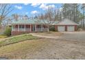 Beautiful brick home with a green metal roof and a two-car garage, complemented by a well-maintained front yard at 81 Bowers Rd, Moreland, GA 30259