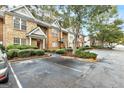 Brick townhome exterior featuring lush landscaping and parking area at 3802 Austin Park Ln, Decatur, GA 30032