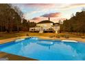 Large backyard pool surrounded by lounge chairs and an expansive deck, perfect for outdoor entertaining at 203 Shelby Ln, Fayetteville, GA 30215