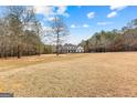 Elegant two-story home with a spacious front yard, classic architecture, and a charming porch with columns at 203 Shelby Ln, Fayetteville, GA 30215