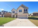 Charming two-story home featuring a well-manicured lawn, large driveway, and a welcoming front entrance at 316 Denton Way, Hampton, GA 30228