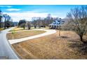 Residential house set back from the road showcasing a circular driveway and mature trees at 111 Dixson Rd, Bowdon, GA 30108
