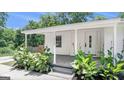 Inviting front porch with decorative plants and a covered entrance at 3132 Emory Sw St, Covington, GA 30014