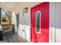Inviting front porch features a bright red front door, modern light fixture, and fresh paint at 200 Adeline Nw Ave, Atlanta, GA 30314