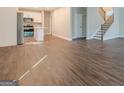 Light-filled living space with wood floors, open to kitchen and staircase at 200 Adeline Nw Ave, Atlanta, GA 30314