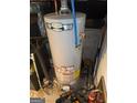 Image of the AC Smith ProLine water heater, including the water pipes, gas lines, and some equipment on the floor at 8794 Homewood Dr, Riverdale, GA 30274