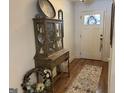 Inviting foyer features hardwood floors, decorative cabinet, and a front door with a wreath detail at 101 Deer Park Dr, Carrollton, GA 30116