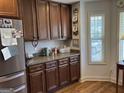 Well-designed kitchen features custom cabinetry, granite countertops, and stainless steel refrigerator at 101 Deer Park Dr, Carrollton, GA 30116