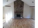 Spacious living room with beautiful hardwood floors and a stunning stone fireplace at 1967 Levgard Ln, Riverdale, GA 30296