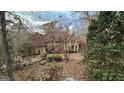 Angle view of a stylish home featuring mature trees and beautiful landscaping at 275 Old Mill Ct, Fayetteville, GA 30214