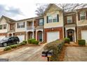 Exterior shot of townhomes with tidy landscaping, mailboxes, and convenient driveway parking at 2786 Snapfinger Mnr, Decatur, GA 30035