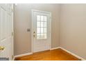 Bright foyer with hardwood floors, a white door with glass panes, and neutral wall paint at 2786 Snapfinger Mnr, Decatur, GA 30035