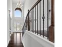 Elegant foyer features high ceilings, dark hardwood floors, and a staircase with iron railings at 5915 Langdale Chase # 16, Douglasville, GA 30135