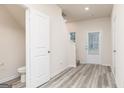 Inviting entryway with wood-look floors, white doors, and natural light, showcasing a clean and modern design at 295 Limestone Circle, Conyers, GA 30013