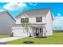 Stylish two-story home with white siding, a two-car garage, a covered front porch, and a freshly landscaped yard at 295 Limestone Circle, Conyers, GA 30013