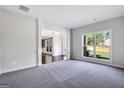 Spacious living room with plush carpeting, large windows with views, and elegant column accents at 5905 Langdale Chase # 17, Douglasville, GA 30135