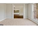 Elegant living room featuring neutral carpet, white trim and ample natural light from the window at 6600 Wansfell Ct # 28, Douglasville, GA 30135
