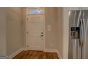 Bright entryway features a tiled floor, neutral walls, and convenient access to the refrigerator at 5118 N Pratt St, Covington, GA 30014